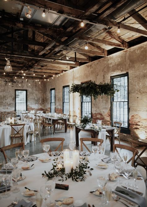 industrial bohemian wedding reception in brick building. Round tables, greenery, string lights Bohemian Wedding Reception, Industrial Wedding Inspiration, Rustic Wedding Decorations, Summer Bride, Simple Centerpieces, Green Wedding Shoes, Wedding Cake Designs, בר מצווה, Industrial Wedding