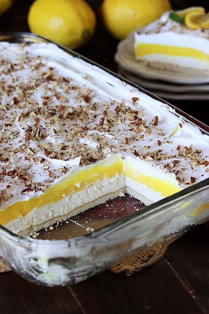 Lemon Lush in Baking Dish Cut to Show Layers Inside Image Keto Lemon Lush, Gluten Free Lemon Lush Dessert, Lemon Trifle Recipes Layered Desserts, Lemon Torte Desserts, Lemon Lush Dessert With Golden Oreos, Lemon Delight Dessert, Lemon Lush Cake, Peanut Butter Lush Dessert, Lush Cakes Dessert Recipes