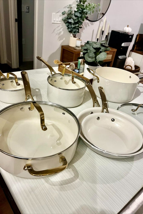 Riveted gold handles add a regal touch to any kitchen, securely attached with stainless steel rivets for a sturdy grip that exudes confidence. Ceramic Interior, Frying Pans, Linen White, Gold Handles, Cookware Set, Dutch Oven, Pots And Pans, Saute Pan, Martha Stewart