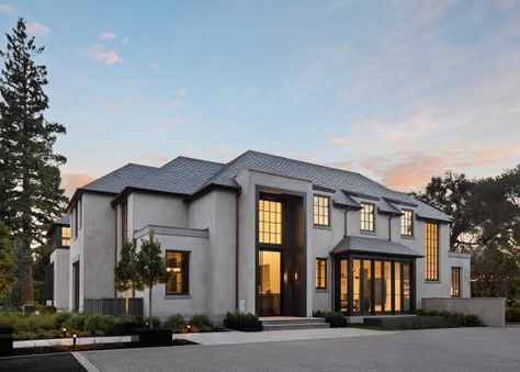 This dramatic driveway leads to a modern manor with exquisite curb appeal. In the back, a luxurious pool house rubs shoulders with a grand patio and pool, and atmospheric globe lights loop over an endless table in a massive dining area. Outdoor Gathering Space, Studio Green, House System, Post Modern, Maine House, Dream Home Design, Curb Appeal, Exterior Design, Great Rooms