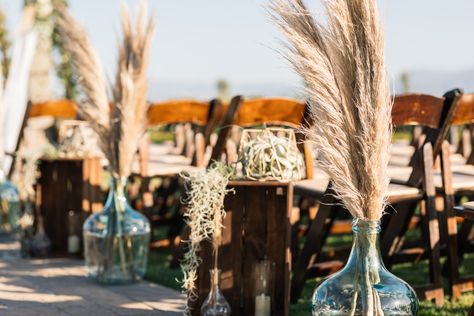 wooden | white swag | eucalyptus | white roses | baby's breaths | pampas grass | large glass jugs | wooden crates | faux candles | barrel podium | vineyard backdrop   Florist: Terri Yang @ Love Note Events Photo Cred: Aldous Photography Glass Gallon Jug Wedding Decor, Glass Jug Wedding Decor, Glass Jugs Decor Ideas, Glass Jugs Decor, Rustic Ceremony, Jug Decor, Wedding Swag, Wedding Alters, Ceremony Aisle