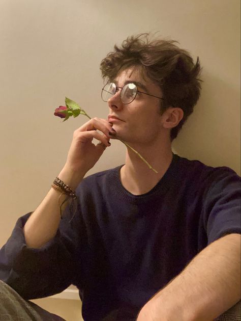 man sat against a white/beige wall in a blue jumper and chequered trousers, holding a rose against their face Charlie Bennett, Barber Style, Nerdy Guys, Brown Hair Men, Haircut 2024, Boys Glasses, Mens Haircut, Men Haircut, Men's Haircut