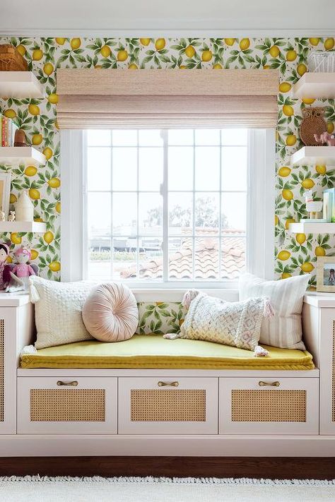 White floating shelves mounted to a wall clad in Lulu & Georgia Lemon Wallpaper flank a window located over a built-in window seat finished with lattice drawer fronts and topped with a yellow seat cushion. Built In Window Seat, Window Seat Design, Style Me Pretty Living, Big Girl Rooms, Window Seat, Banquette, Nurseries, My New Room, Home Decor Ideas