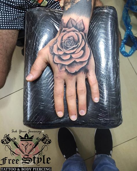 rose tattoo on hand realistic rose tattoo Rose Tattoo Design On Hand, Hand Tats Men Rose, Hand Roses Tattoo, Hand Rose Tattoo Design, Rose Tattoo In Hand, Hand Rose Tattoo Men, Black Rose Hand Tattoo, Rose Hand Tattoo Design, Rose Hand Tattoo Men