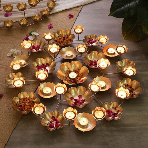 This gorgeous Urli/Tealight stand with mini diyas and urlis looks absolutely stunning when placed on your center or side table in the living room or can be used to decorate your pooja room. This beautiful and affordable gold polished rangoli urli/tealight stand also makes an amazing gift option for your family and frie Urli Bowl, Lotus Rangoli, Marriage Anniversary Gifts, House Warming Ceremony, Diwali Decoration Items, Diwali Decoration, Floating Flowers, Return Gift, Diwali Festival