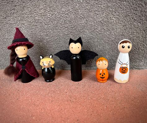 Hand made 3" wooden peg dolls for Halloween: *Felt witch with broom (green, burgundy, or black)  *Bat *Ghost *Cat (child) *Pumpkin (child or adult) *Bunny (child) Custom hair color available. Create a spooky village with trick or treaters, or display as mantle / shelf decor. Montessori toys: Peg dolls provide endless opportunities for imaginative play and creative expression. Halloween Peg People, Halloween Peg Dolls, Peg Dolls Halloween, Fall Theme Peg Dolls, Hocus Pocus Peg Dolls, Halloween Wooden Peg Dolls, Addams Family Peg Dolls, Vampire Peg Doll, Bunny Pumpkin