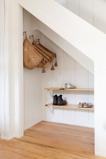 Storage space is essential in small home, and the woven bags provide more room to store hats and mittens in the winter. Under Stairs Nook, Room Under Stairs, Stair Nook, Space Under Stairs, Closet Under Stairs, Stairs Renovation, Diy Staircase, Staircase Storage, Under Stairs Cupboard