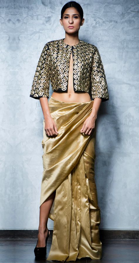 Embroidered black short cape jacket with a gold lungi fit silk skirt by NIKHIL THAMPI http://www.perniaspopupshop.com/lakme-fashion-week/nikhil-thampi/nikhil-thampi-cape-blouse-and-skirt-set-nktlfw081302.html New Trend Dress, Nikhil Thampi, Saree Wearing Styles, Sari Design, Modern Saree, India Fashion Week, Cape Jacket, Haute Couture Dresses, Lakme Fashion Week