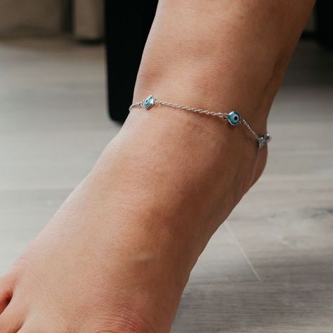 Is evil eye real or not? It's an age-old question of the forthcoming generation. Maybe you aren't the type to believe in it, but what if you are? Hey, what's the need to take a risk? Want a 2 in 1 anklet which deals with 'Nazar' (evil eye) and is rather impactful on your outfit? 'The colorful Aura' has a collection of such jewelleries. Where you don't need to worry about someone's evil gaze while rocking off your fit! If your thoughts meet the above conditions, then you should definitely conside Anklets Silver, Handmade Evil Eye, Beautiful Anklet, Summer Anklets, Evil Eye Protection, Turkish Evil Eye, Beach Anklets, Turkish Design, The Embrace