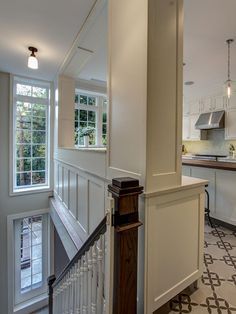 The stairway to a lower-level family room backs up to the traditional kitchen in this Brooklyn townhouse. A wide pass-through window opens up the space, bringing in lots of natural light and giving an airy feel to what could otherwise be a cramped galley kitchen. Traditional Townhouse, Old Kitchen Remodel, Kitchen Pass Through, Colonial Kitchen Remodel, Kitchen Pass, 1970s Kitchen Remodel, Inexpensive Kitchen Remodel, Galley Kitchen Layout, Brooklyn Townhouse