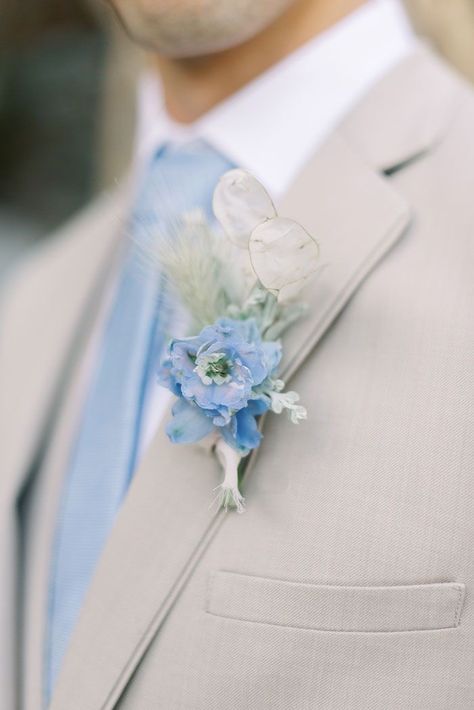 Blue Groomsmen Boutonniere, Powder Blue Wedding Suit Groom, Powder Blue Boutonniere, Beige And Blue Groomsmen Suits, Tan Tux With Dusty Blue, Beige Blue Wedding Theme, Light Blue Champagne Wedding, Tan Suit Light Blue Tie, Light Blue And White Beach Wedding