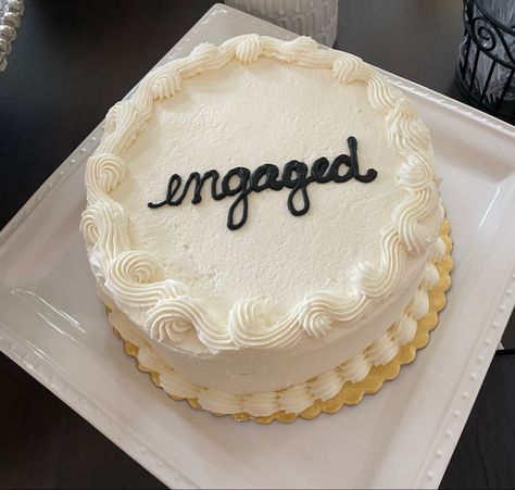 Engagement party cake with simple script letters. The cake says engaged in black script font. Simple cool girl engagement party cake. Cake cutting at engagement party. Simple engagement cake ideas. Wedding cake ideas Simple White Engagement Cake, Surprise Engagement Party Decorations, Engagement Party Cake Ideas Simple, We’re Engaged Cake, Black And White Engagement Cake, White And Black Engagement Party, Engagement Party Small, Engagement Cakes Simple, Black And White Engagement Party Decor