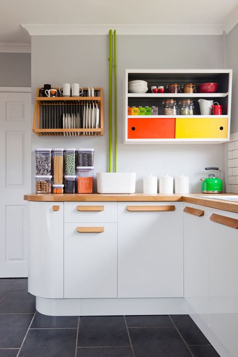 This Bold, Eye-Popping English Home is for Color Lovers | Apartment Therapy White Colorful Kitchen, Wooden Handle Kitchen, White Kitchen Wooden Handles, Primary Colour Kitchen, Wooden Handles Kitchen, White Kitchen With Color, 1960 Kitchen, 1960s Bungalow, Real Kitchens