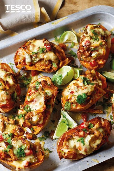 Be inspired by Mexico with these chicken fajita sweet potatoes. Sweet potatoes are loaded with peppers and spicy chicken, then topped with melting cheese and fresh coriander for a colourful family meal. | Tesco Melting Cheese, Wallpaper Food, Tesco Real Food, Chicken Fajita, Family Meal, Sweet Potato Recipes, Spicy Chicken, Limes, Sweet Potatoes