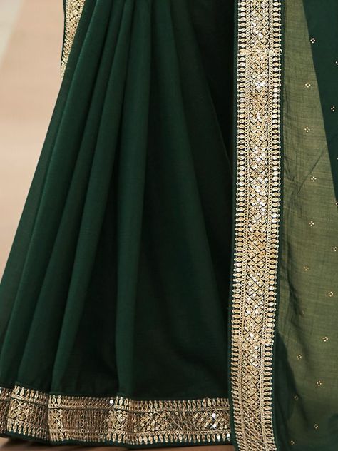 <ul> <li>Make a strong fashion statement with this striking dark green-colored lively wear saree. The saree is designed of vichitra fabric developed with Swarovski, zari, dori work, sequins, thread embroidery, and stonework, and also has tassels on the edge of the saree.</li> <li>This stunning saree reaches with a wine-colored banglori material blouse built with beautiful Dori work, thread, and sequins embroidery work and also has a round neckline.</li> <li>Th Dark Green Saree, Pink Saree Blouse, Dori Work, Character Vibes, Reception Saree, Diamond And Silk, Green Thread, Saree Blouse Designs Latest, Green Saree