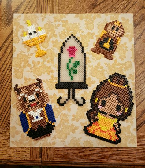 Perler Bead Beauty and the Beast. God bless! Beauty And The Beast Fuse Beads, Beauty And The Beast Perler Bead Pattern, Disney Melty Beads Patterns, Perler Bead Art Disney, Disney Princess Perler Beads, Disney Pearler Beads, Tangled Perler Beads, Beauty And The Beast Perler Beads, Godzilla Perler Beads