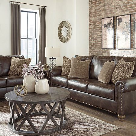 Enticing with a coffee brown faux leather, beautified with a gently weathered effect and designer stitching, this sofa merges a richly traditional sense of style with modern comfort. Roll arms, turned bun feet and prominent nailhead trim incorporate distinctive character. Four plush accent pillows are a sumptuous touch. Frame constructions have been rigorously tested to simulate the home and transportation environments for improved durability. Frame components are secured with combinations of gl Coffee Living Room, Dark Brown Couch, Brown Leather Couch Living Room, Leather Couches Living Room, Brown Couch Living Room, Brown Leather Couch, Coffee Sofa, Leather Sofa Living Room, Cozy Fall Decor