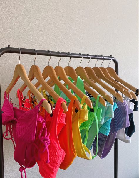 Rainbow swimsuits on clothing rack Rainbow Swimsuit Bikinis, Swimsuit Collection Aesthetic, Swimsuit Organization, Swimsuits Aesthetic, Bright Swimsuit, Beach Vacation Essentials, Rainbow Swimsuit, Neon Swimsuit, Swimsuit Aesthetic