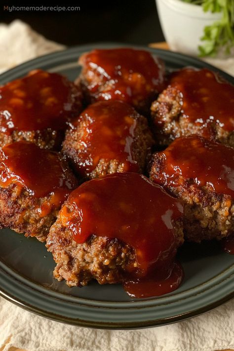 Delicious and cheesy mini meatloaves with a sweet and tangy ketchup glaze, baked to perfection for a comforting family meal.