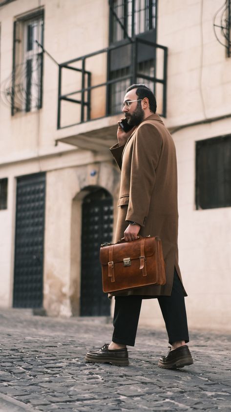 A man's briefcase can serve many functions. It is the vehicle the lawyer uses to organize and transport case files while away from the office. It's the carryall for the commuter who brings along his paperwork and computer. It's a fine alternative to the traditional backpack for the student with a sense of style. In short, a briefcase is the bag into which you can place all the various items you might need throughout the day. Because these items may include a laptop or tablet, your phone and wall Cognac Satchel Briefcase For Business Trips, Brown Satchel Briefcase For Business Meetings, Professional Brown Briefcase For Work, Mens Laptop Bag, Mens Work Bags, Camel Leather Bag, Leather Business Bag, Mens Satchel, Vintage Briefcase