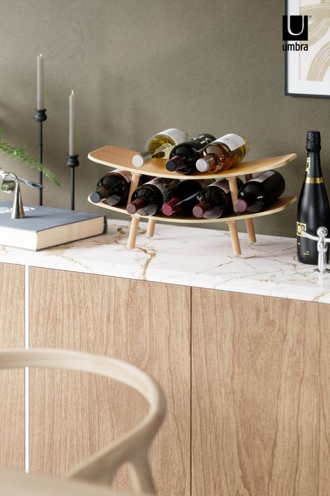 VINOLA WINE RACK - store your favorite bottles with this unique wine rack. With rounded curves and a real-wood finish, Vinola looks great out on display on your countertop, table and more. Available on umbra.com Wine Rack Table, Countertop Wine Rack, Kitchen Dish Rack, Wood Countertop, Countertop Display, Wine Display, Wine Store, Soap Pump, Dish Racks