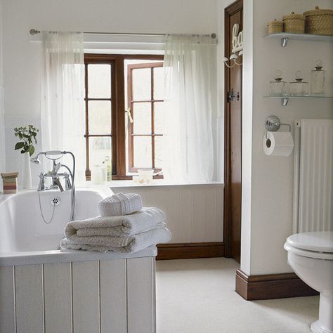 Light and fresh bathroom    Simple cream tongue and groove contrasts beautifully with the dark wood skirting boards and cupboard door in this bathroom. Glass shelving is ideal for tidying away toiletries, white flooring keeps the room light. Small Country Bathrooms, Compact Bathroom Design, Country Bathroom Designs, Dark Wood Trim, Fixer Upper Bathroom, Classic Bathroom Design, Elegant Bathroom Design, Traditional Bathroom Designs, Primitive Bathrooms