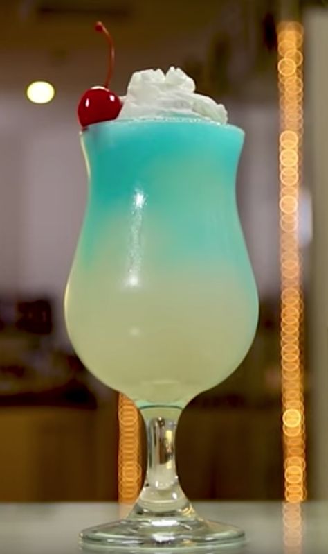 Lovers of slushy tropical cocktails will go wild for this Ocean Blue drink, trust us. This gorgeous beachy coconut rum drink mixes up blue curacao, pineapple juice, and piña colada mix, and is garnished with whipped cream and a cherry for even more fruity tropical mixed drink tastiness. Bahama Mama Drink, Tropical Mixed Drinks, Easy Pina Colada Recipe, Coconut Cocktails, April Vacation, Coconut Rum Drinks, Tropical Cocktails, Fruit Slush, Pina Colada Recipe