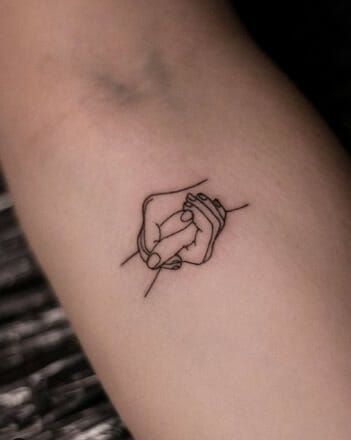 Tattoo For Someone Special, Tattoos Of Holding Hands, Tattoo Of Holding Hands, Hands Holding Tattoo Design, Hold Hands Tattoo, Hand Hold Tattoo, Helping Hands Tattoo, Hands Together Tattoo, Helping Hand Tattoo