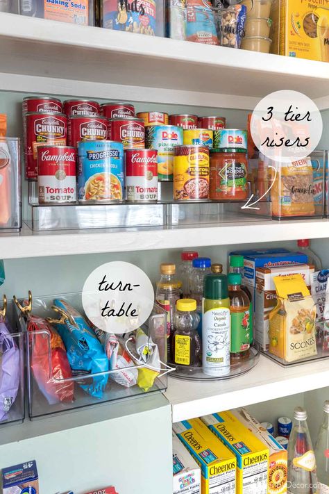 Pantry with tiered risers and turntable for organization Pantry Organization For Canned Goods, Pantry Organization The Home Edit, Pantry Organization Turntable, Kitchen Food Organization Cabinets, Storage Ideas For Canned Goods, Pantry Organization Ideas For Cans, Pantry Organization With Clear Bins, Pantry Organization Simple, Pantry Organization Home Edit