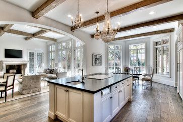 Open concept floor plan for Kitchen, Breakfast, and Living Room areas. Large windows and French doors allow lots of natural light to pour in. Warm neutral color scheme, custom reclaimed oak wood flooring, rough-sawn wood ceiling beams, soapstone slab countertop on kitchen island with built-in paper towel holder, undermount bar sink, and inset cabinet doors. (image by Parker House Inc., via Houzz) Living Room Wood Floor, Kitchen Design With Island, Oak Wood Floors, Open Concept Floor Plans, Wood Beam Ceiling, Kitchen Design Open, Kitchen And Dining Room, Parker House, Trendy Living Rooms