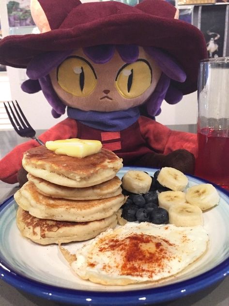 Niko from Oneshot plushie infront of pancakes and fruit juice. Pancakes