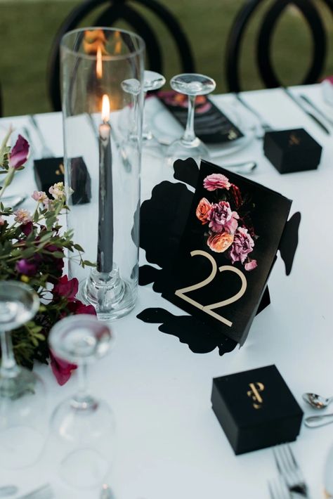 Bold black and magenta florals created a unique Greek beach wedding