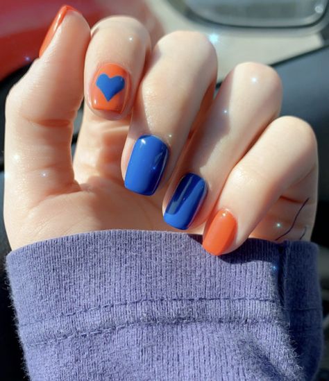 Blue and orange heart nail art Orange And Blue Manicure, Blue Orange Nail Art, Blue Orange Nails Acrylic, Orange Blue Nails Art Designs, Blue Orange Nail Designs, Nail Orange Design, Gator Nails Designs, Nails Orange And Blue, Blue And Orange Nail Ideas