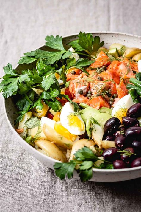 This Salmon Nicoise salad recipe is a main-dish salad that is perfect for a weeknight meal. Packed with crispy vegetables, briny olives, and homemade mustard olive oil vinaigrette, it is not only delicious but also visually pleasing. #nicoise #nicoisesalad #frenchfood #recipe #salad #healthy #foolproofliving #healthysaladrecipes #healthysalad #saladrecipe #foolproofliving Nicoise Salad Dressing, French Salad Recipes, Classic Tuna Melt, Salmon Nicoise, Salmon Nicoise Salad, Crispy Vegetables, Nicoise Salad Recipe, Homemade Mustard, Healthy Main Dishes