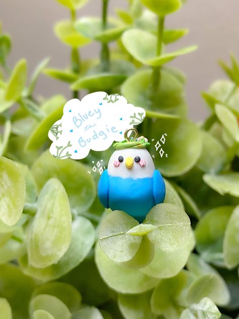 Blue Budgie Bird Charm made out of polymer clay. With a flower crown brushed with gold paint! A keychain charm or a necklace charm. Polymer Clay Bird, Budgie Bird, Clay Pigeons, Budgies Bird, Clay Bird, Big Leaves, Cute Polymer Clay, Bird Charm, Polymer Clay Charms