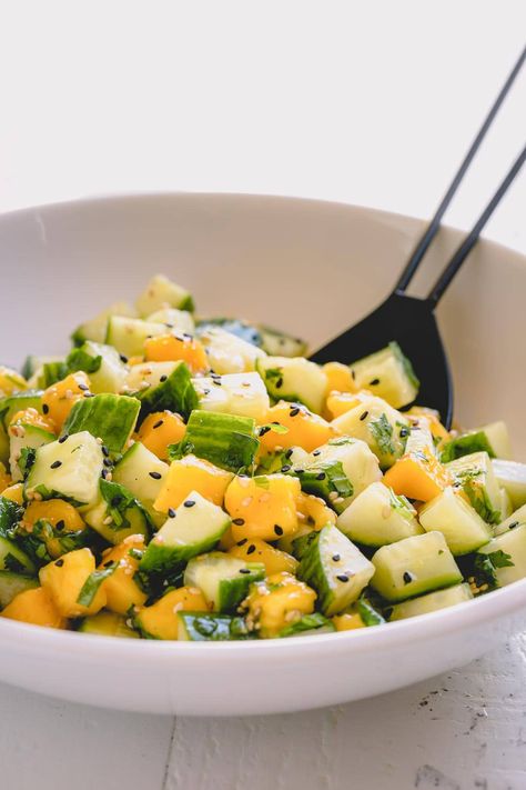 Mixed with flavorful Asian dressing, this light and refreshing cucumber mango salad is the perfect side for grilled meats and roasted salmon. Mango Cucumber Salad, Cucumber Salad Dressing, Mango Salad Recipe, Cucumber Mango, Asian Dressing, Cucumber Salad Recipe, Cucumber Diet, Grilled Meats, Grape Salad