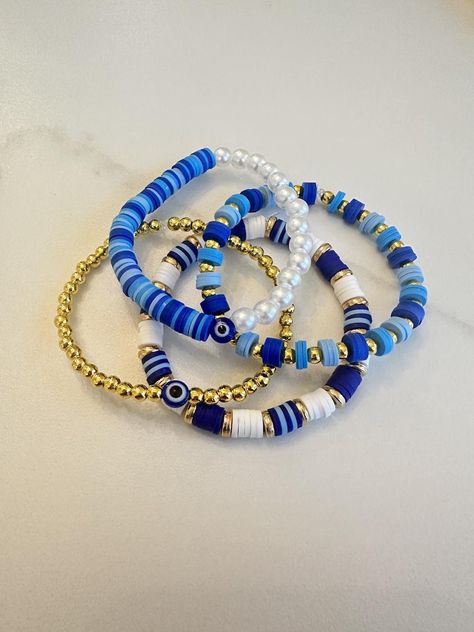 Blue and gold clay bead bracelet collection. Star Clay Bead Bracelet, Navy Blue Clay Bead Bracelets, Dark Blue Clay Bead Bracelet, Bracelet Ideas Clay Beads Aesthetic, Cool Clay Bead Bracelet Ideas, Clay Bracelet Idea, Clay Beads Aesthetic, Clay Bead Brackets, Slay Bracelets