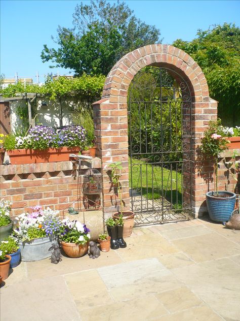 Brick arch metal garden gate in our garden Brick Archway Exterior, Bricked Archway, Garden Archway Ideas, Garden With Bricks, Brick Gate, Archway Ideas, Brick Garden Wall, Brick Wall Gardens, Arch Gate