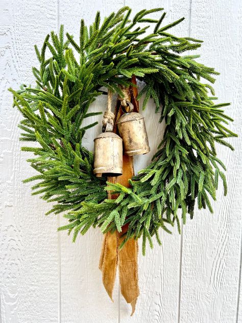 Real touch Norfolk Pine makes the most beautiful wreaths! I have several in my shop so be sure to check them all out! The one pictured has rustic gold bells and caramel-gold, velvet, distressed ribbon tails. A true eye catcher with beautiful Christmas curb appeal. You could even add a strand of micro lights to make it really pop!   All measurements are approximate  25"  * As with any wreath, some fading may occur over time if placed outdoors or in direct sunlight Please be sure to check your message/conversation notifications regularly until your order is received. I may have questions about specifics.  Thank you so much for shopping with me. I hope you've enjoyed your time at the Mercantile! Christmas Diy Felt, Christmas Boxwood, Boxwood Wreath Christmas, Pine Christmas Wreath, Green Christmas Tree Decorations, Greenery Christmas, Farmhouse Christmas Wreath, Wreath Greenery, Christmas Door Wreath