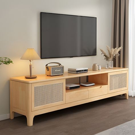 This mid-century TV stand is crafted from rubber solid wood, showcasing the natural wood tone. With the addition of woven rattan elements on the cabinet doors, it exudes a minimalist yet highly designed aesthetic. It's a creatively inspired piece that will serve as the perfect finishing touch for your living room. Tv Unit For 75 Inch Tv, Meja Tv Aesthetic, Wooden Cabinets Living Room, Tv Cabinet Design For Living Room, Wooden Tv Table, Minimalist Tv Unit, Rattan Tv Unit, Tv Cabinate, Rattan Tv Cabinet