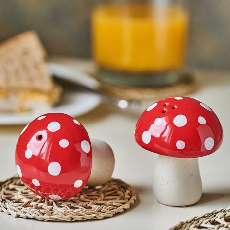 These hand painted mushroom salt & pepper shakers will give every dining table an original touch.     Crafted from ceramic to create our mushroom design.     Featuring a colourway of soft white, cream and red.     A wonderful and affordable gift or a great addition to your collection of kitchen accessories. Dimensions W 6.00 x L 6.00 x H 7.50 cm Made from Ceramic Mushroom Salt And Pepper Shakers, Mushroom Kitchen Decor Ideas, Mushroom Kitchen Theme, Mushroom Ceramics Ideas, Red Mushroom Art, Mushroom Kitchen Decor, Mushroom Things, Mushroom Room, Cute Salt And Pepper Shakers