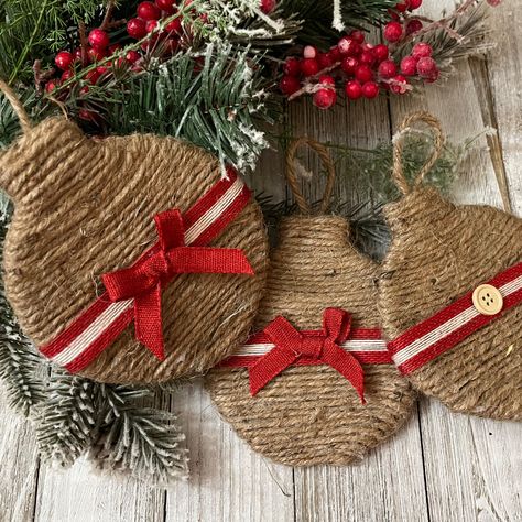 These are wood ornaments wrapped in twine with a bow on the front and a button on the back. The size is 4" x 4.75". Twine Ornaments Diy, Wood Ornament Ideas, Jute Ornaments, Xmas Ornaments Diy, Wood Round Ornaments, Recycled Ornaments, Eco Friendly Christmas Decorations, Round Christmas Ornaments, Burlap Christmas Decorations