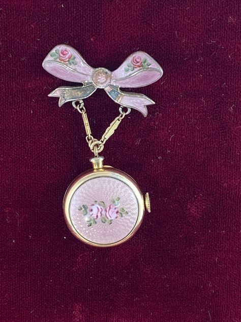 Vintage Harman Broach WW2 Boy Friend Pin with Bow Ribbon Watch  hand made Pink Guilloche Enamel with 2 Roses Pin Bow also with small rose buds Brooch Pin 1.25 inches wide 2 inches tall inch Bow and watch is 7/8 inch in diameter. This is Hand made from the 40's Harman 7 Jewel Movement Manual watch in a Bronze 12K Karat Gold plated  known as a boy friend pin during WW2 Vintage Harman Watch Not working hand made Guilloche Enamel with Pink Roses Balance ticks for a few seconds, balance does turn fre Rose Watch, Ribbon Pin, Guilloche Enamel, Pink Aura, Bow Ribbon, Neck Jewellery, Small Rose, Jewelry Lookbook, Fantasy Jewelry