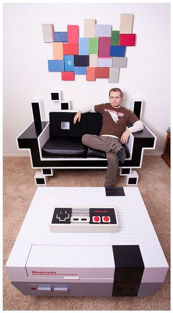 Check out this custom Space Invader couch. It is sure to bring the nostalgia feeling to the room. Add in with it a custom Nintendo Coffee Table & you're set! If that's not enough, take a look at that NES controller on the coffee table. That's right, it WORKS! Gaming Furniture, Game Room Ideas, Geek Decor, Space Invaders, Video Game Room, Pac Man, Geek Culture, Gaming Room, My New Room