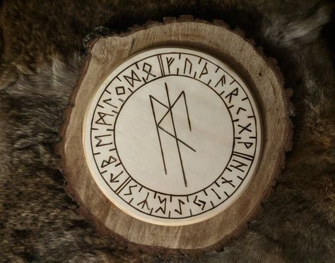 Burned sealed wood altar plate, featuring a bind rune of Eir, the Norse physician goddess of healing (Eihwaz, ingwaz, raidho) encircled by the Elder Futhark runic alphabet. It is lightweight enough to hang if desired but sturdy enough to hold a candle, bowl, etc. Measures 7 diameter. Eir Goddess, Elder Futhark Alphabet, Goddess Of Healing, Viking Heritage, Norse Legend, Symbole Viking, Norse Gods, Runic Alphabet, Pagan Decor