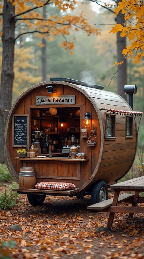 A rustic wooden coffee caravan with a weathered finish, vintage details, and a cozy autumn setting in the forest. The small café serves warm drinks and has a welcoming atmosphere. Wooden Caravan, Coffee Caravan, Mobile Coffee Shop, Autumn Woods, Mobile Coffee, Coffee Business, Warm Drinks, Cozy Coffee, Vintage Aesthetics