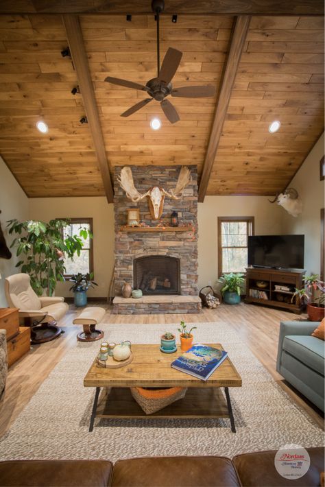 Get cozy in this rustic living room with wood vaulted ceiling and stone fireplace. #farmhouse #openfloor #rustichome #modernfarmhouse #rusticlivingroom #rusticdecor #mountainlivingroom #rusticdesign #woodfloors #moosehead #openconcept #woodtrim #mountainfarmhouse #rusticmountain #nordaas #newhouse #buildingnewhome #newhome Wood Vaulted Ceiling, Mountain Living Room, Fireplace Farmhouse, Rustic Stone Fireplace, Vaulted Ceiling Living Room, Rustic Home Interiors, Farmhouse Fireplace, Modern Rustic Homes, Indoor Window