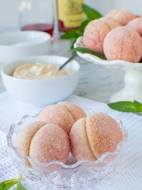 Italian Peach Cookies are two soft cookies sandwiched together with pastry cream then dipped in liqueur to resemble a peach. Traditionally served for holidays and special occasions like baptisms and weddings. These are also a perfect dessert to complete that special dinner. #italianrecipe #italiandessert #authenticitalian #italianpeachcookie Traditional Italian Peach Cookies, Italian Peaches Cookies, Peach Cookies Italian, Italian Peach Cookies, Traditional Italian Desserts, Peach Cookies Recipe, Comfort Baking, Italian Wedding Cookies, Pastry Cream Recipe