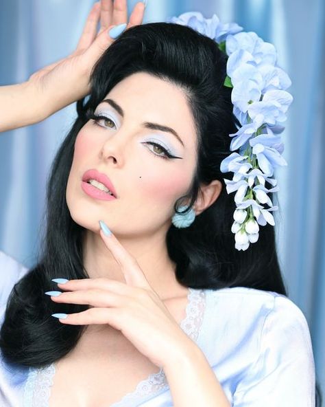 Dafna Beauty on Instagram: "‘Blue Mountains’ 🩵🏔️💙 eyeshadow from our new ‘Mid-Century Pastel Dream’ eyeshadow palette! 💎 The perfect cold 🥶 toned baby blue for any 1950s or 1960s look!   With stunning model @edeneve 😍 Makeup and photography by @dafna_barel  Hair by @edeneve  Hair flowers by @lacasadeflores  Earrings by @glitterparadise  Lipstick is ‘Vintage Mod’ 💋💕" Presley Core, 1960s Looks, Hair Flowers, Priscilla Presley, Stage Makeup, Blue Mountain, Flowers In Hair, Eyeshadow Palette, Baby Blue