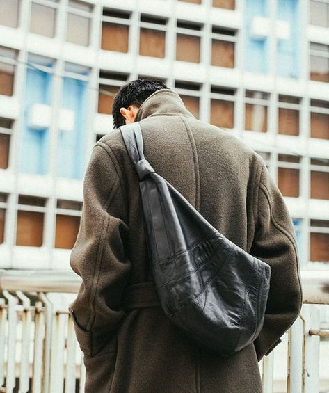 Lemaire on Instagram: "The iconic Croissant bag hugs its wearer, becoming an extension of garments and the body. Pictured here in dark chocolate, worn across the shoulder with the wrap coat, the soft full-grain leather bag is designed for easy, casual wear and effortless pairings. #LEMAIRE" Lemaire Croissant Bag, Croissant Bag, Full Grain Leather Bag, Mens Bags Fashion, Bag Boys, Wrap Coat, Bags Aesthetic, Mens Leather Bag, Coat Outfits